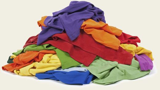 A heap of brightly coloured t-shirts.