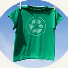 A green recycling t-shirt hanging on a washing line