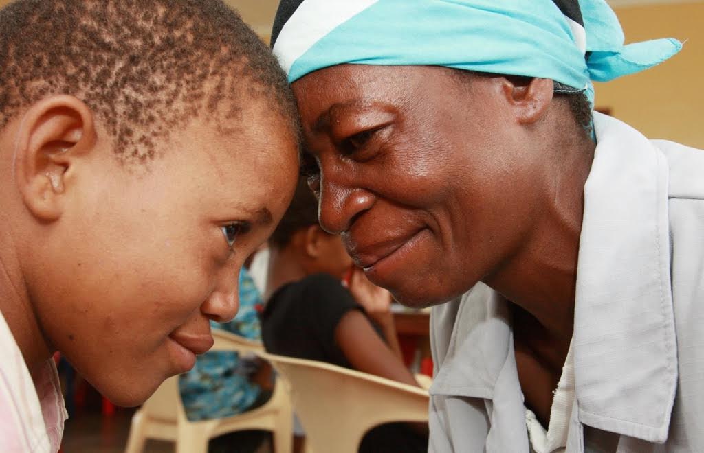 A mother and child sharing a tender moment, foreheads touching